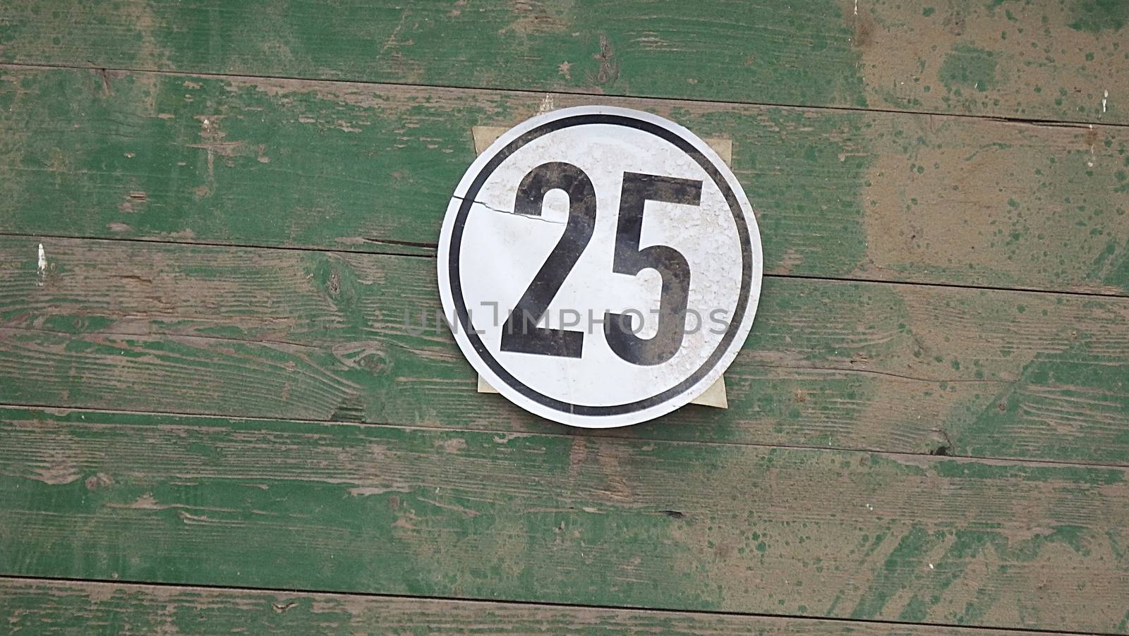 Speed limit 25 mph sign isolated on green background