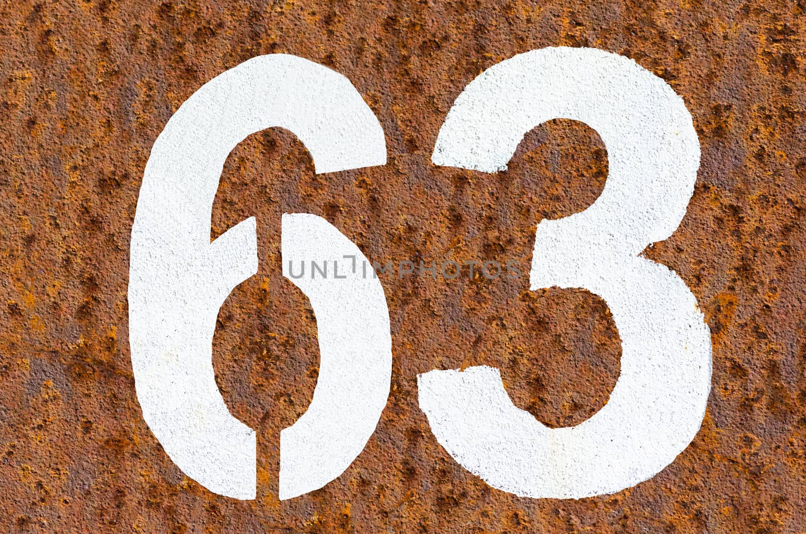 Rusty iron background with beautiful structure and number in white paint.