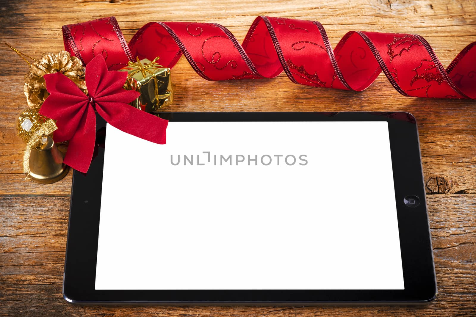 tablet pc with  christmas decorations on wooden background by manaemedia