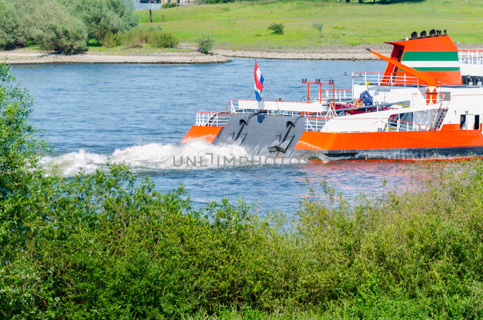 Rear view inland in full speed on the Rhine near Dusseldorf.