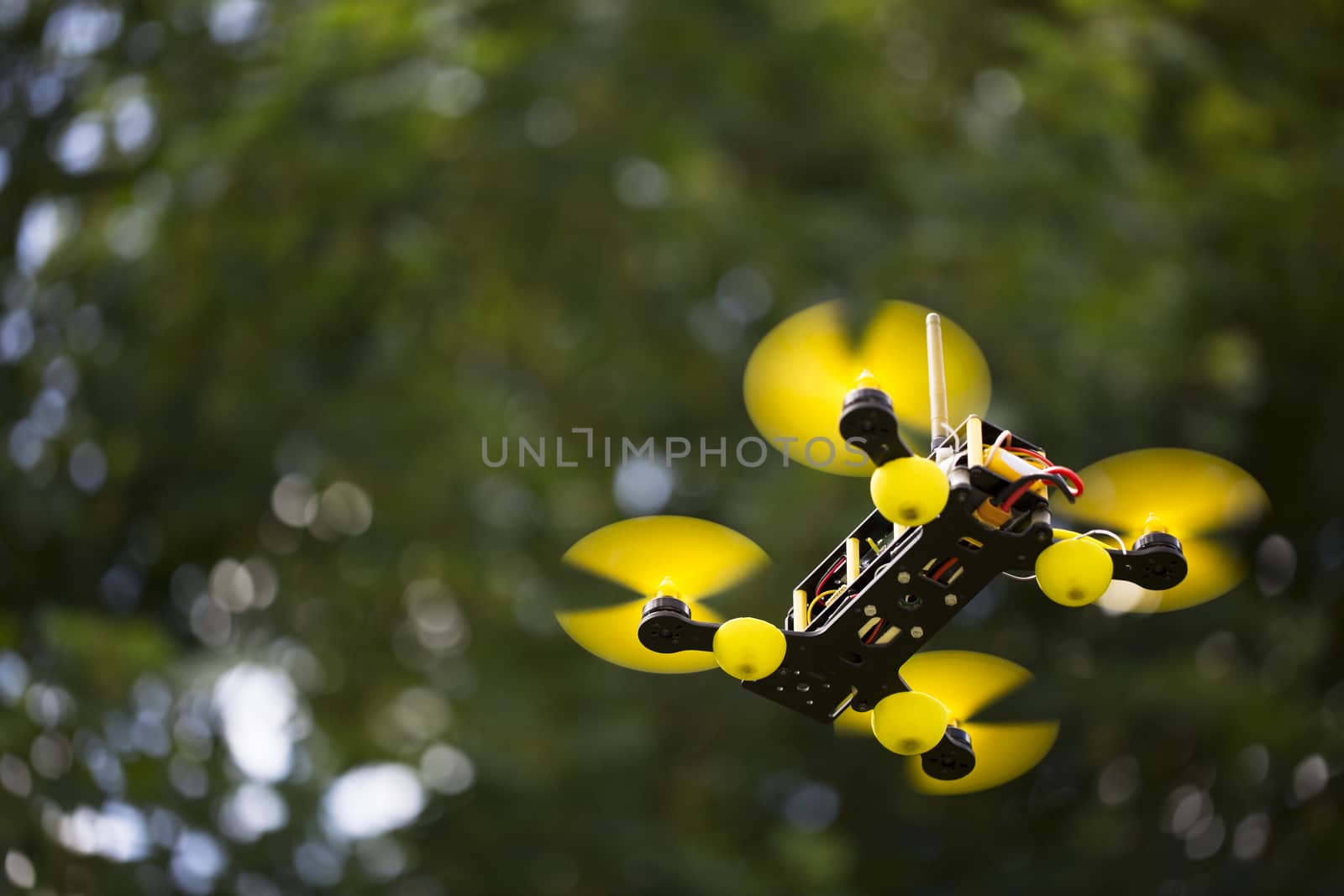 Quadcopter in air with out of focus background.