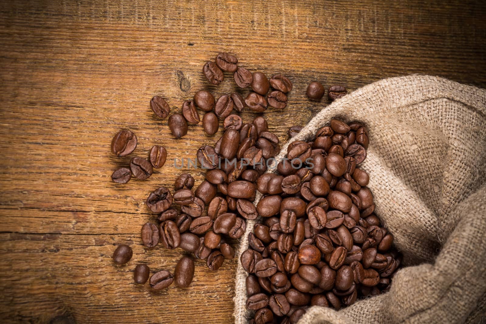 Coffee beans on grunge wooden background. Fresh Roasted coffee beans on vintage table