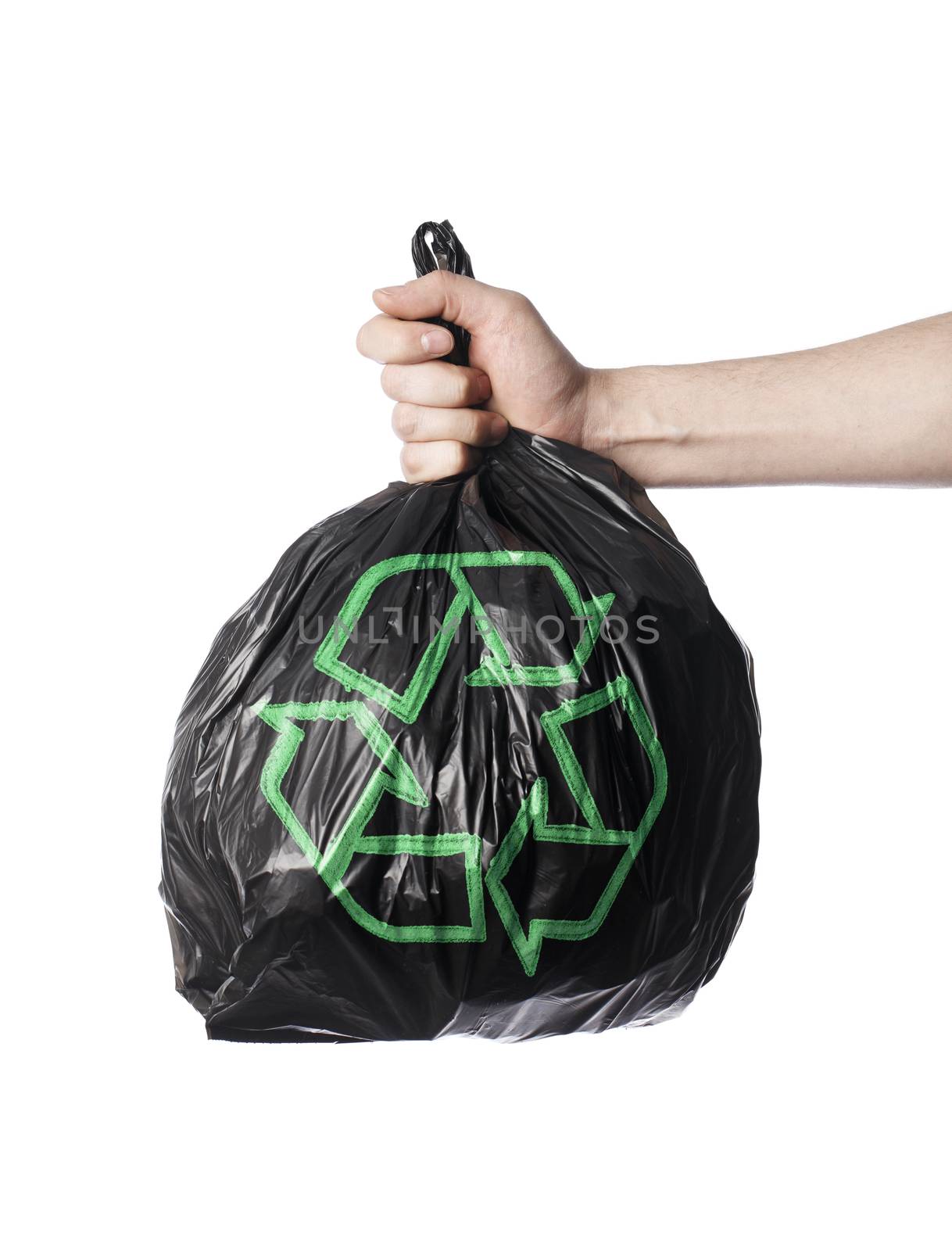 Man holding a black trash back with green Recycling symbol.