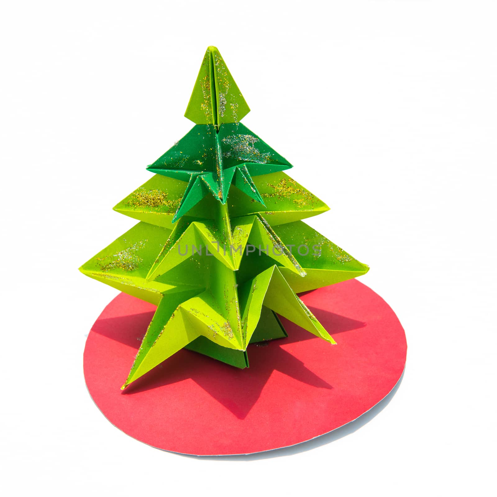 Green origami christmas tree isolated on white background
