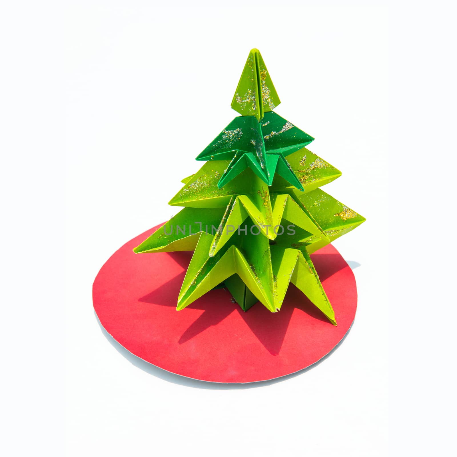 Green origami christmas tree isolated on white background