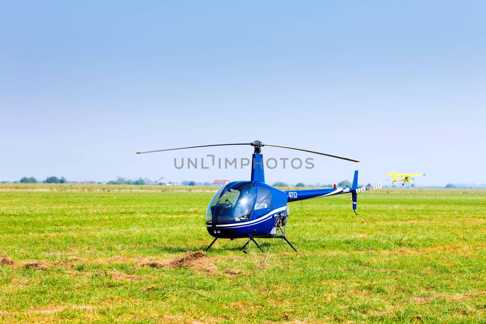 Brasov, Romania - August 12, 2010: Helicopter on a green grass field preparing to take off