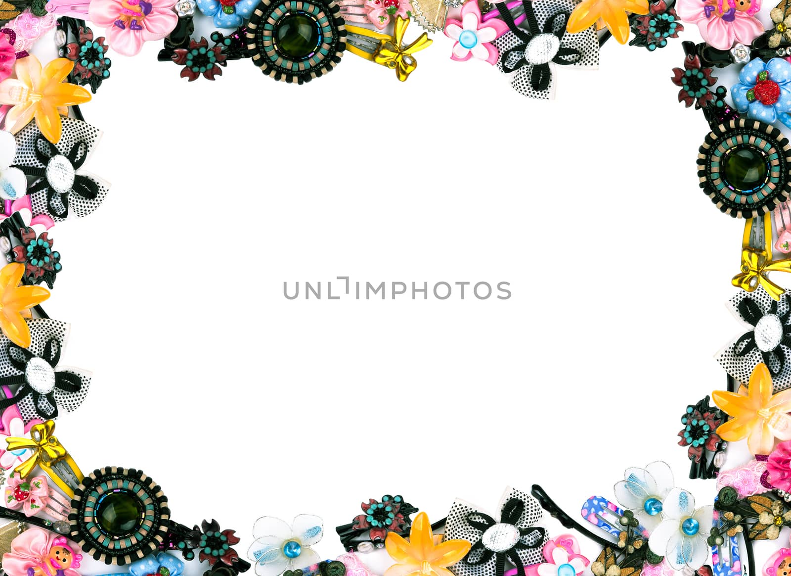 Rectangular decorative frame of the children's variety of colorful pins on a white background
