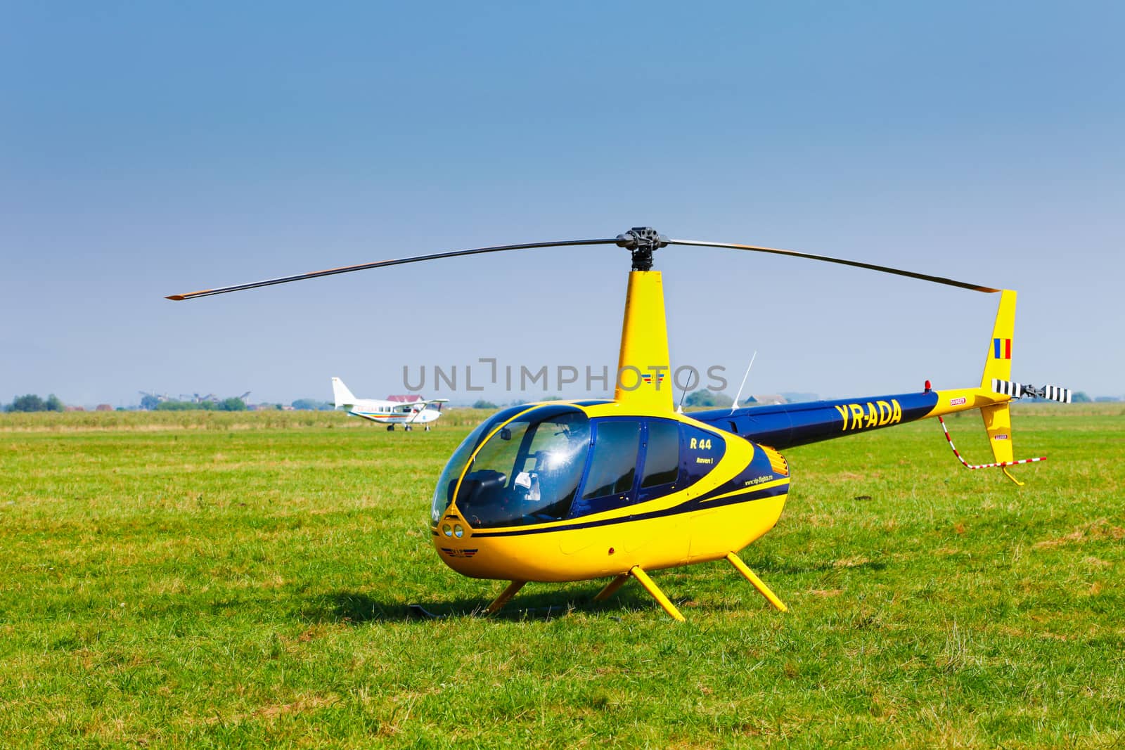 Brasov, Romania - August 12, 2010: Helicopter on a green grass field preparing to take off