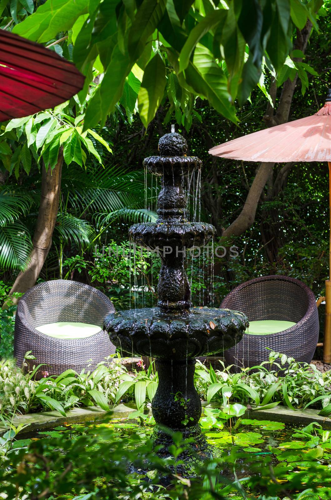 Classic style stone fountain in the garden