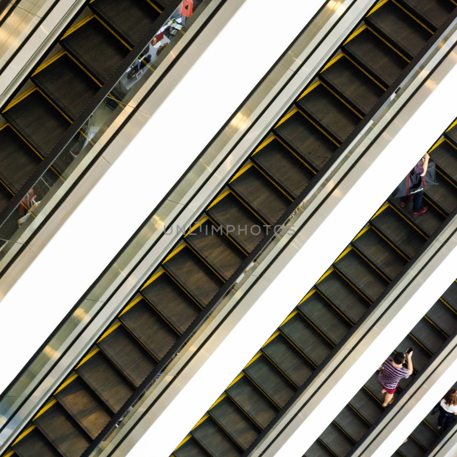 People on escalators at the modern shopping mall. 