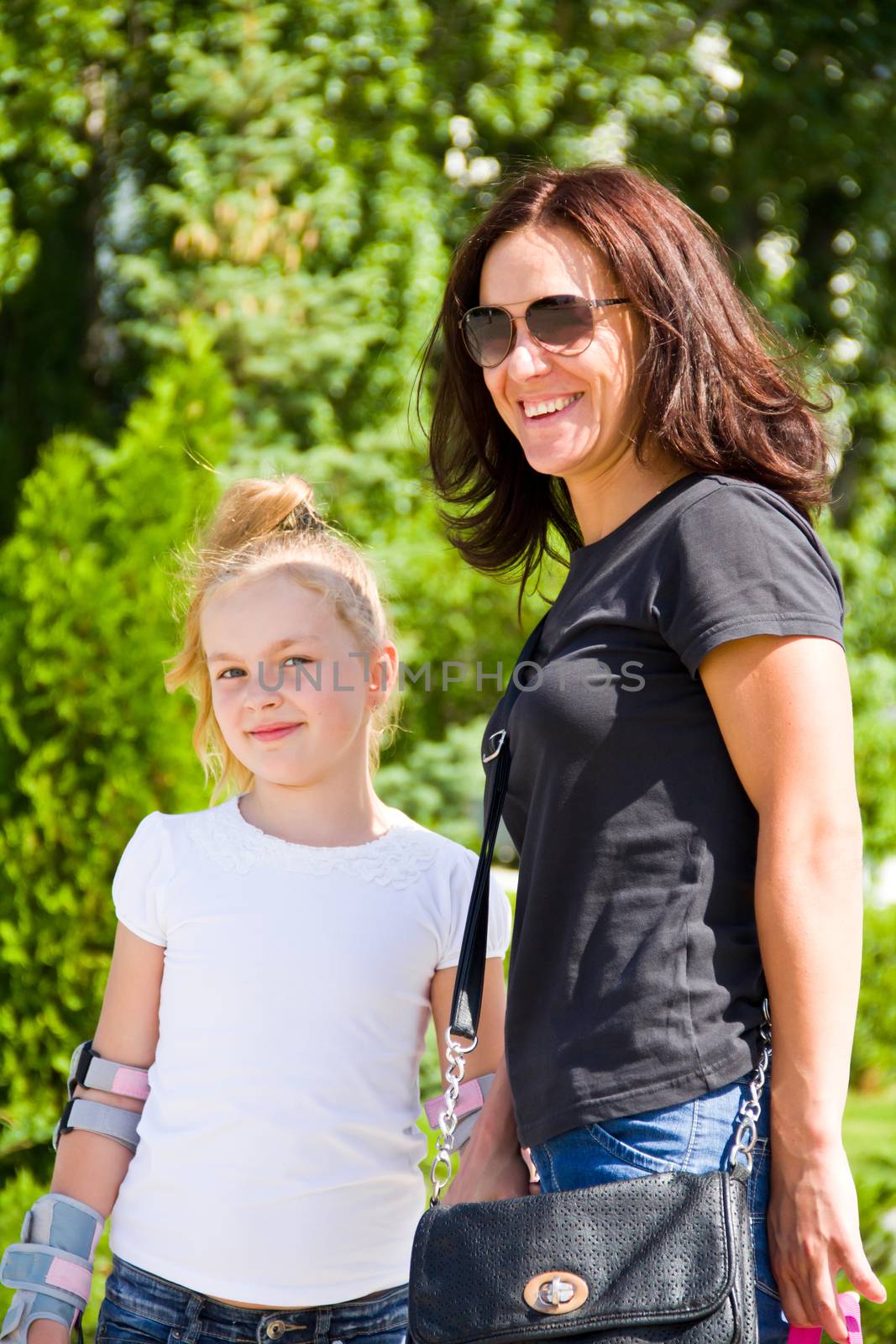 Photo of smiling mother and daughter in summer