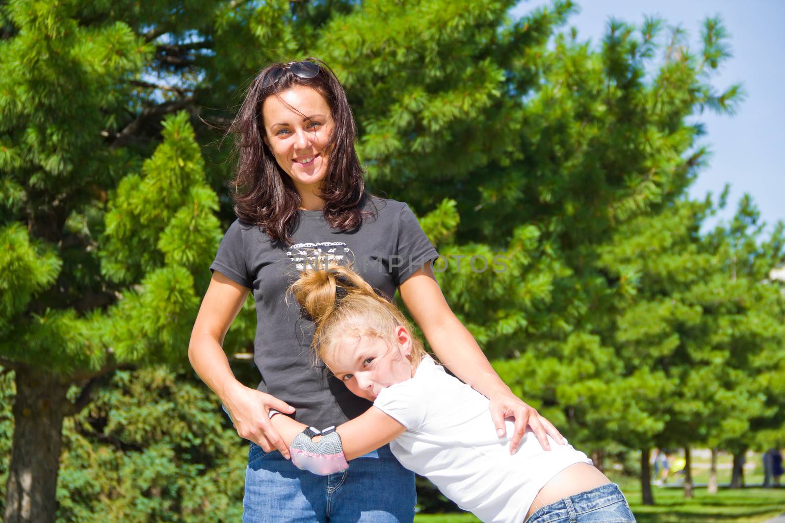 Photo of mother and daughter playing in summer