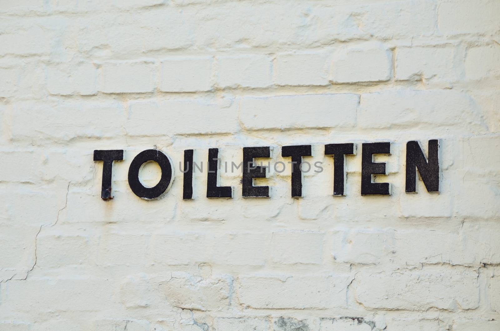 Letters from metal point to a toilet.