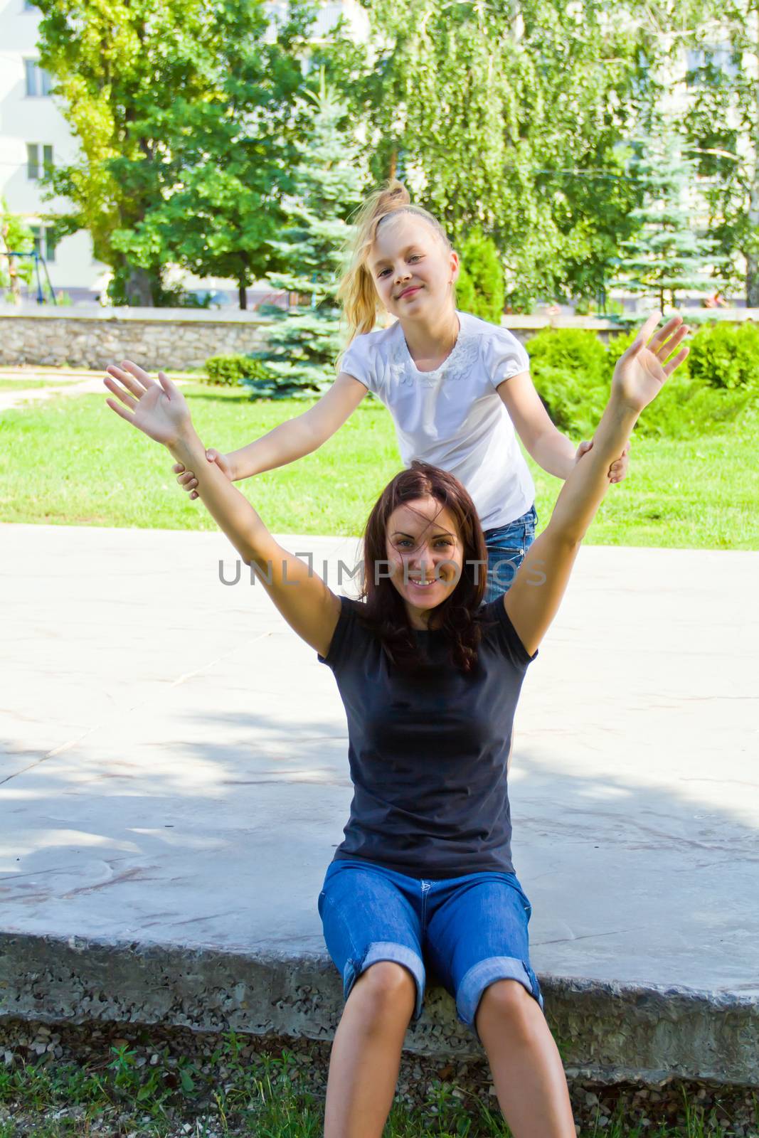 Photo of mother and daughter playing in summer