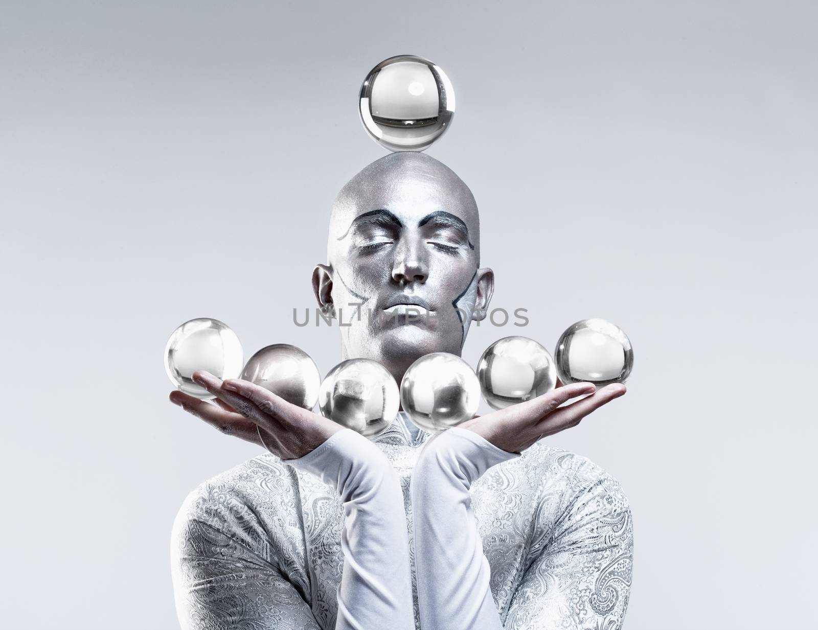 Magician with Glass Balls in Stage Makeup and Costume by courtyardpix