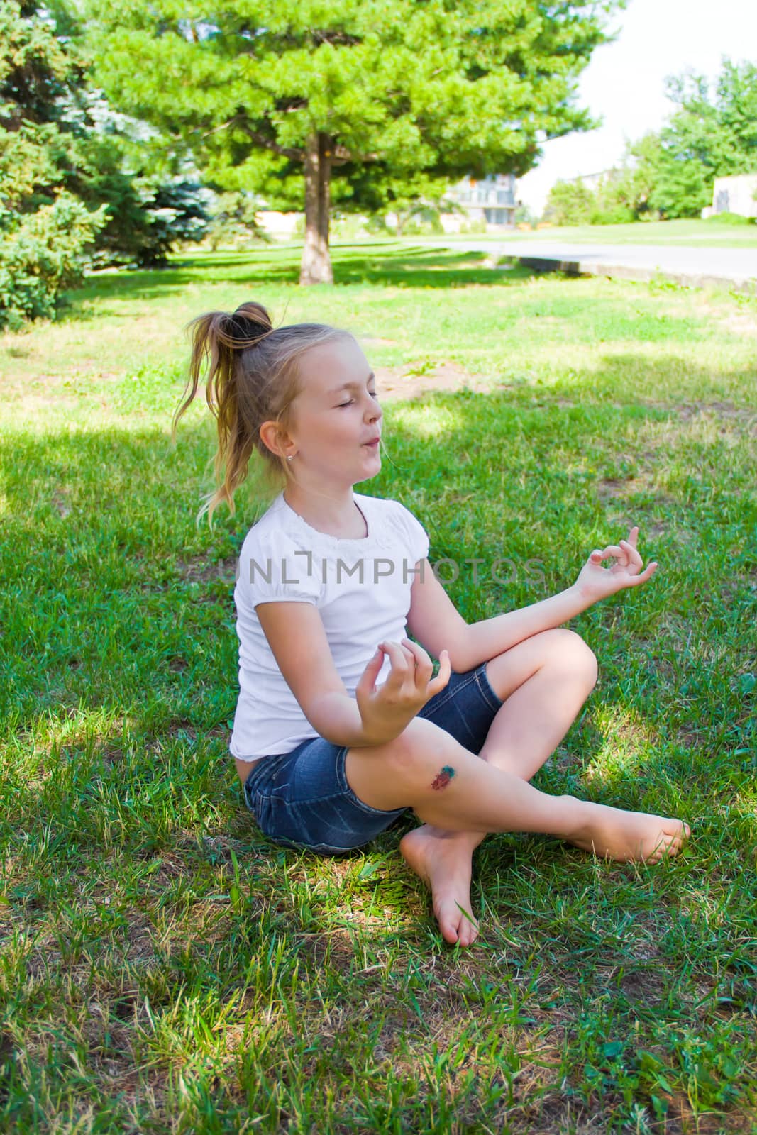 Photo of cute girl in lotus pose with sore knee