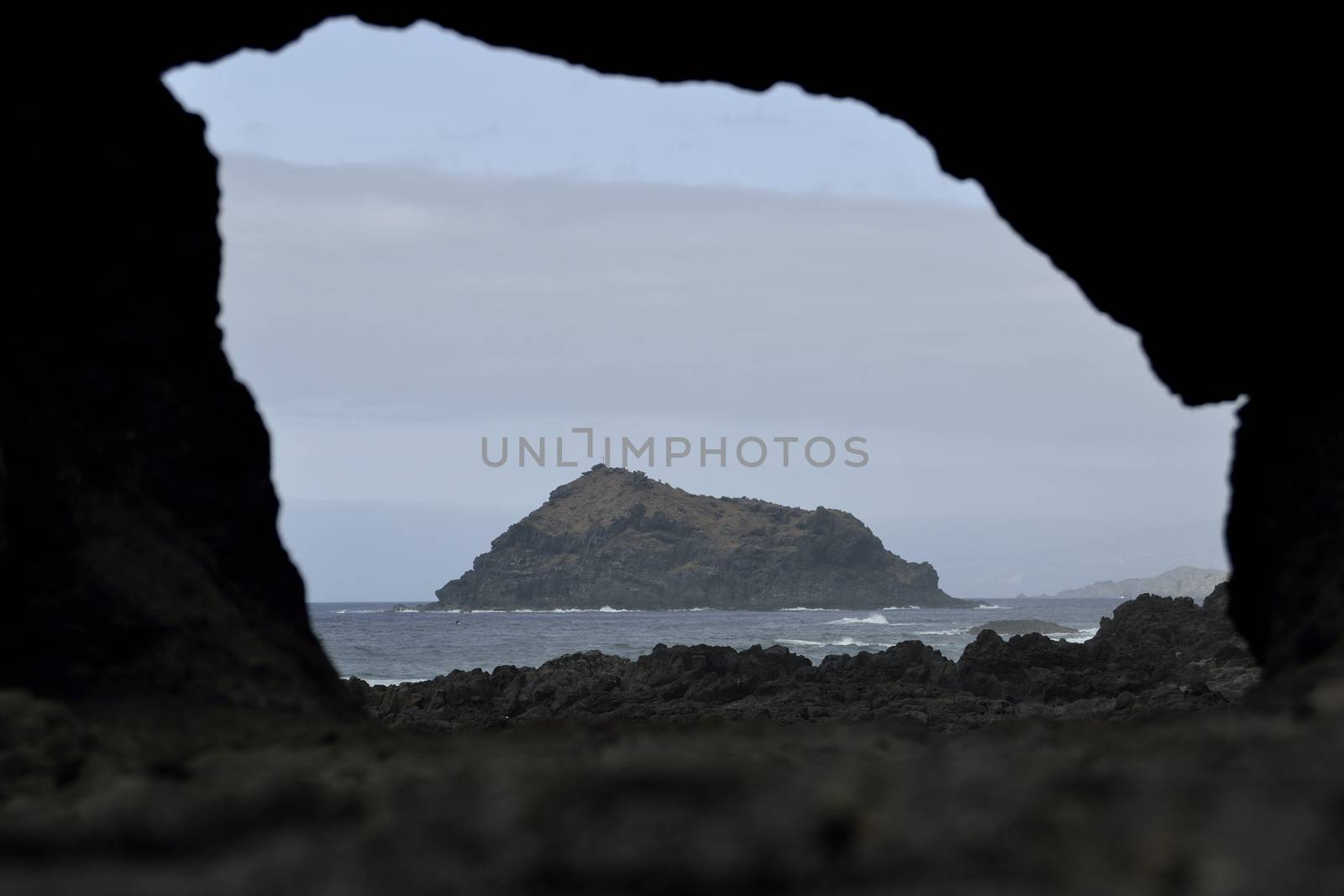 Roque de Garachico through a hole in a rock by ncuisinier