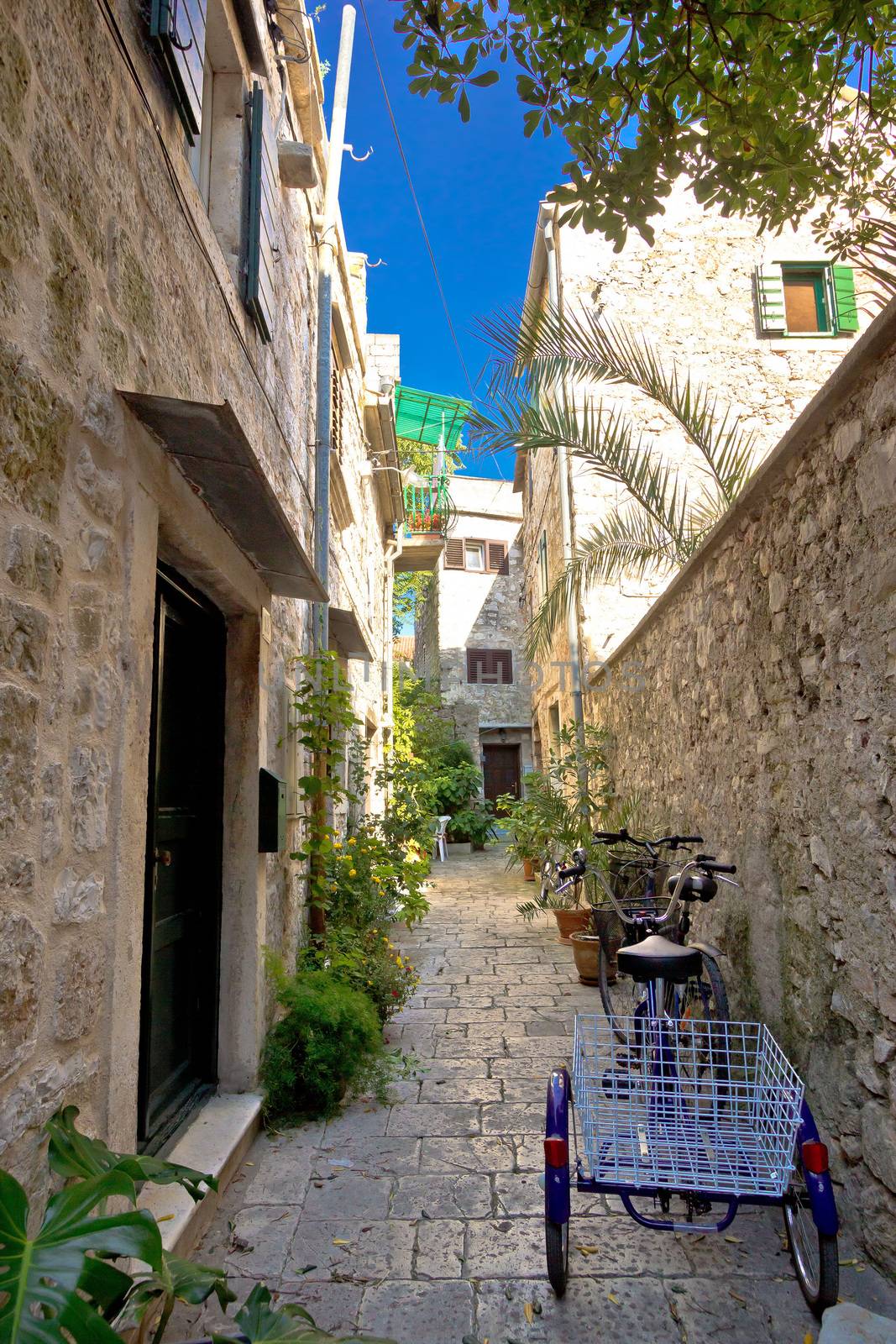 Narrow mediterranean stone street in Stari Grad by xbrchx