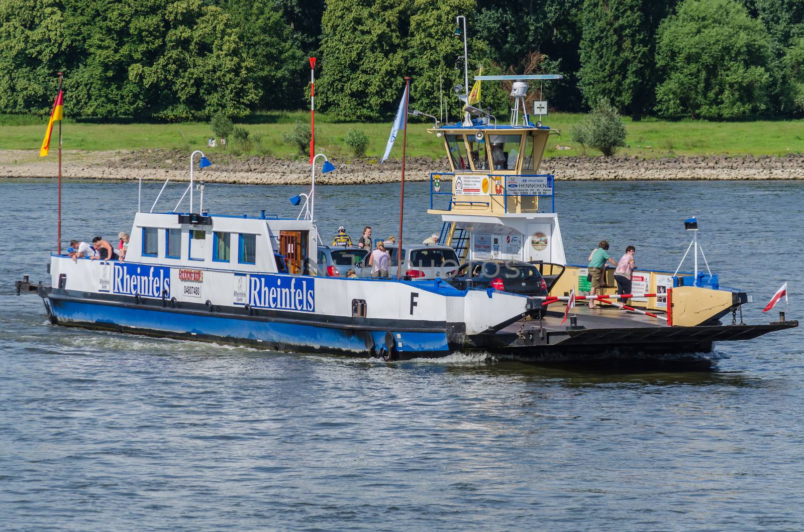 Orsoy, Nrw,  Germany - June 09, 2014:  Ferry City Orsoy on the Rhine. The ferry connects Orsoy in NRW, the city of Duisburg Walsum. Some passengers on the ship