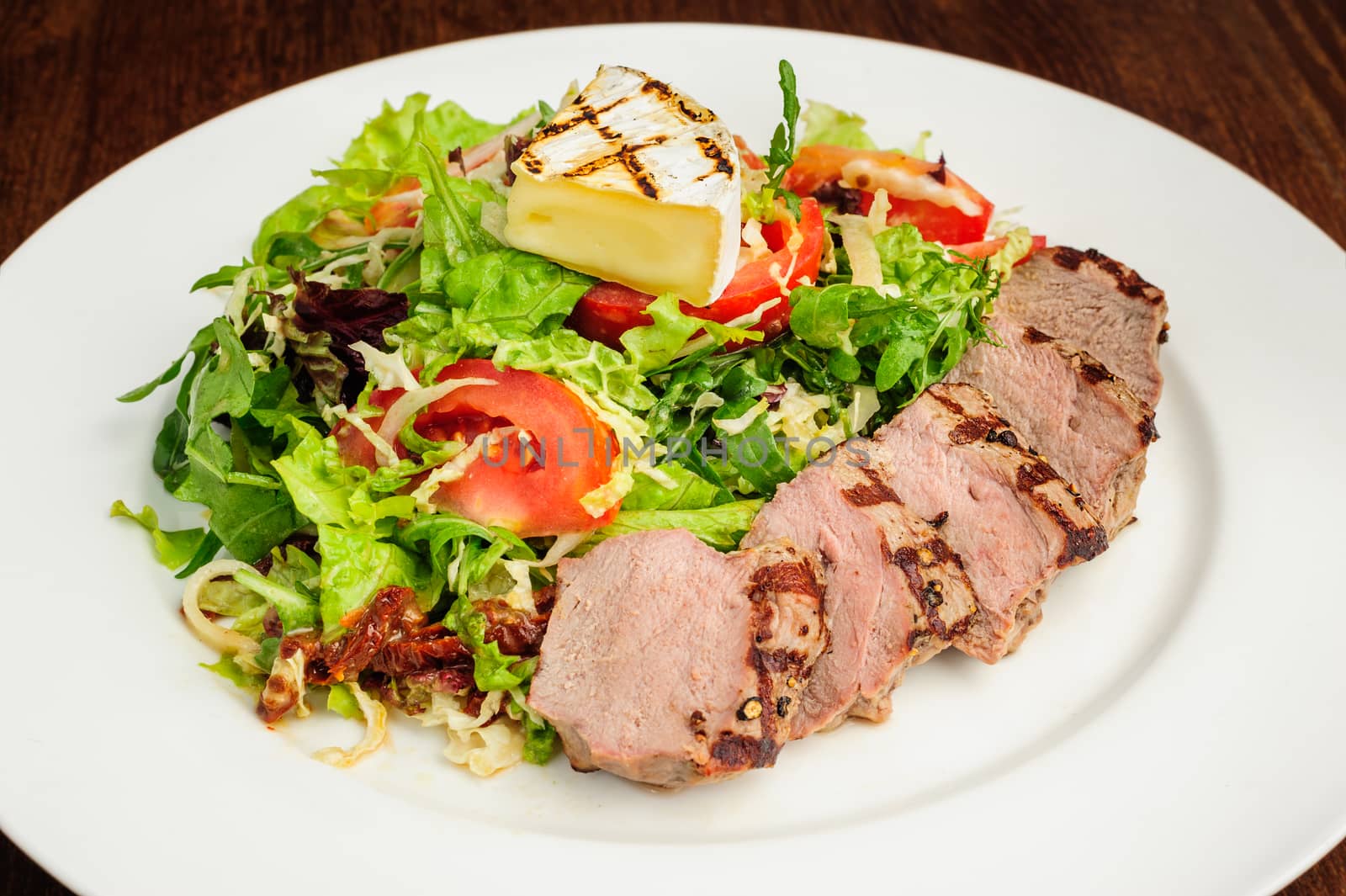 Grill roasted veal meat with fresh vegetable salad