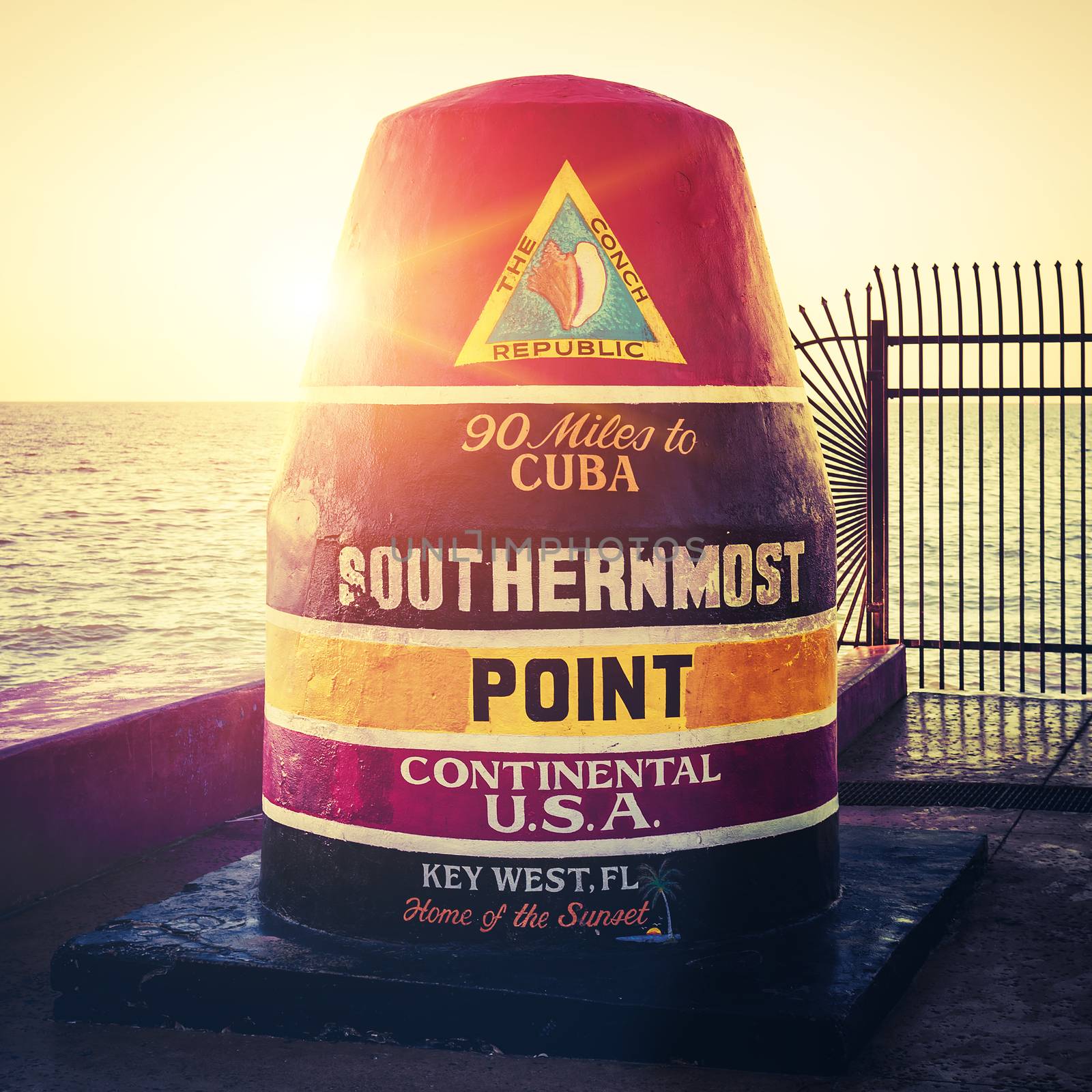 Florida Buoy sign marking the southernmost point at sunset