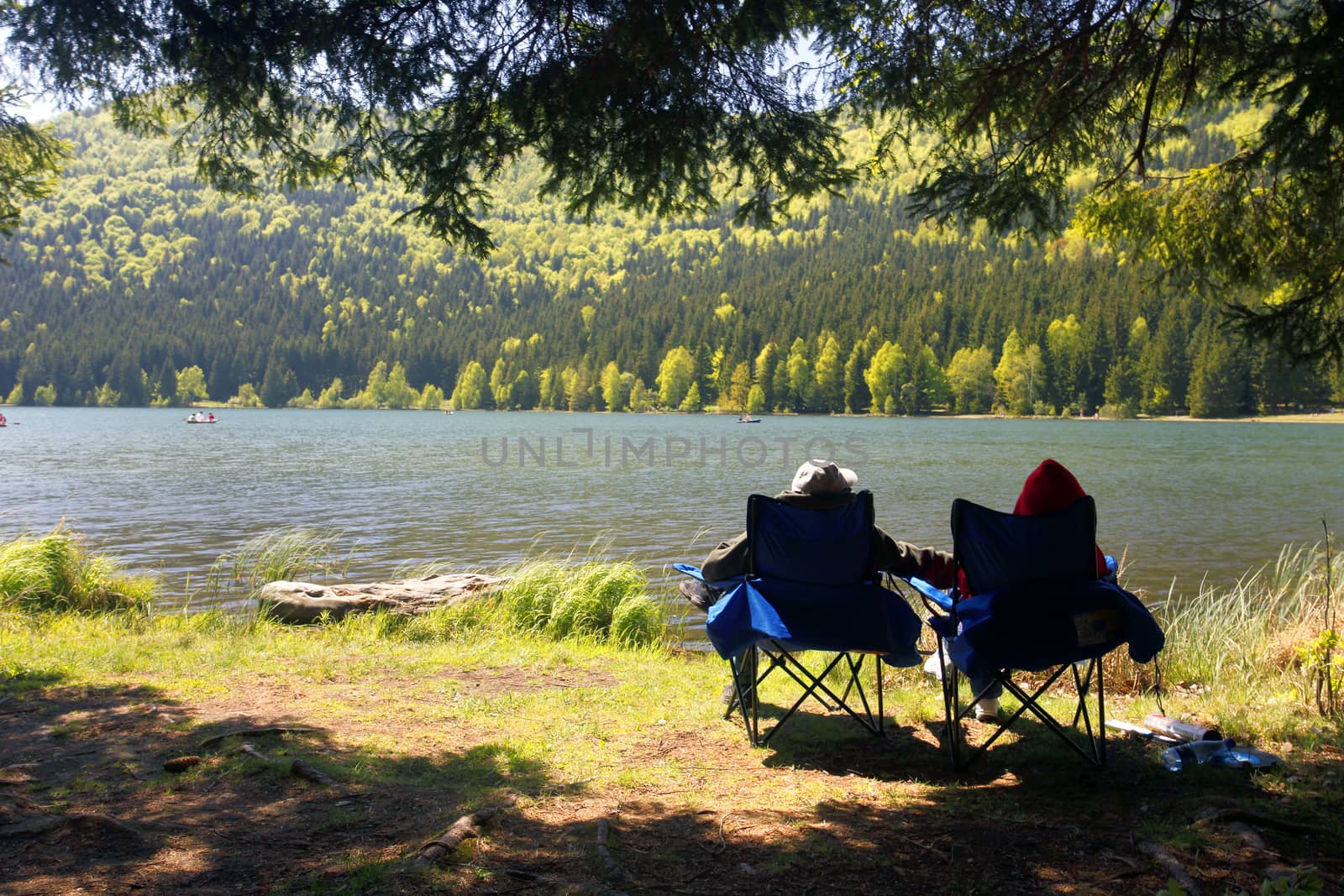 Tourists Couple contemplating on shore St. Ana lake, Romania