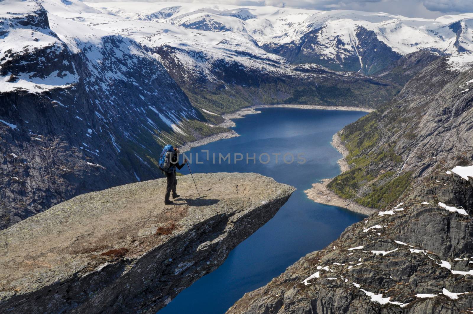 Hiker on Trolltunga, Norway by MichalKnitl