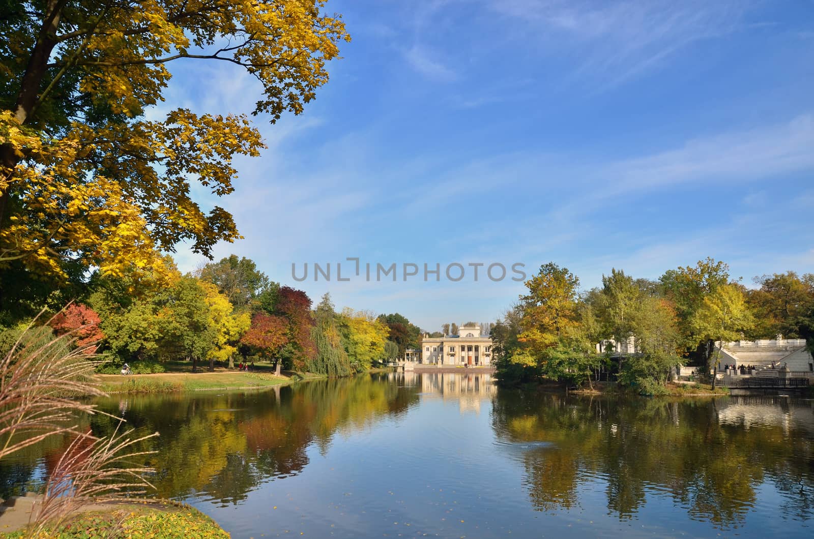 Autumn in Lazienki Park. View over the lake on Royal Palace. South facade of the building.