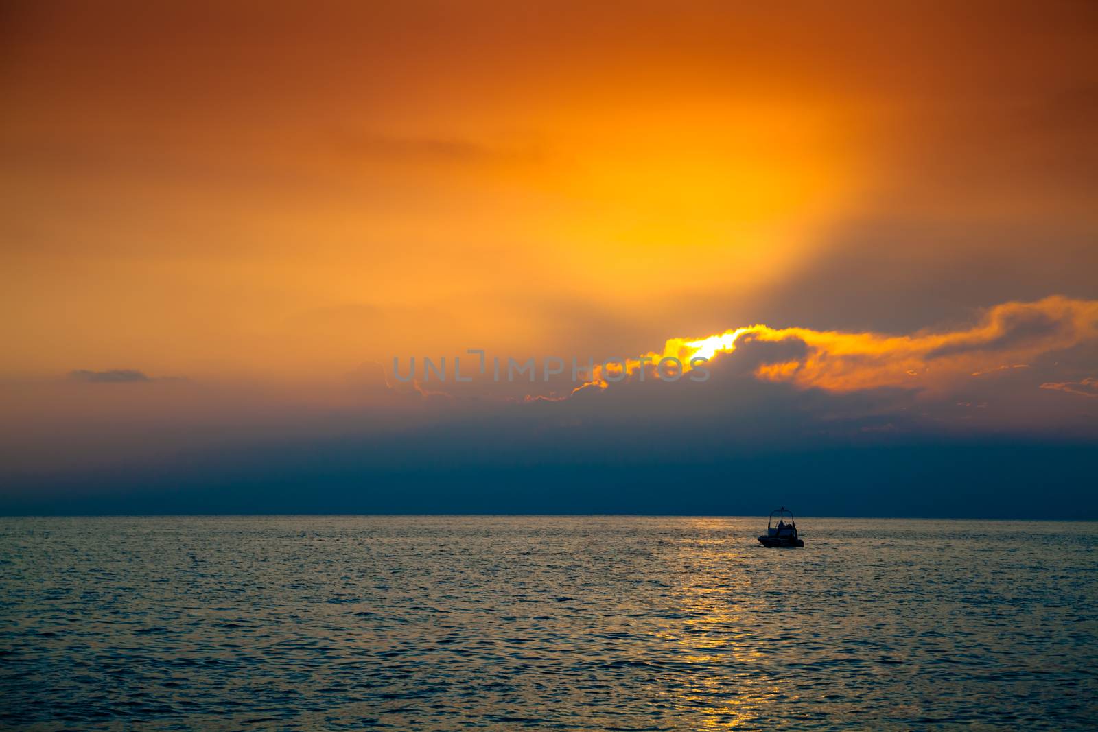 Lone boat in the sea at the beautiful sunset