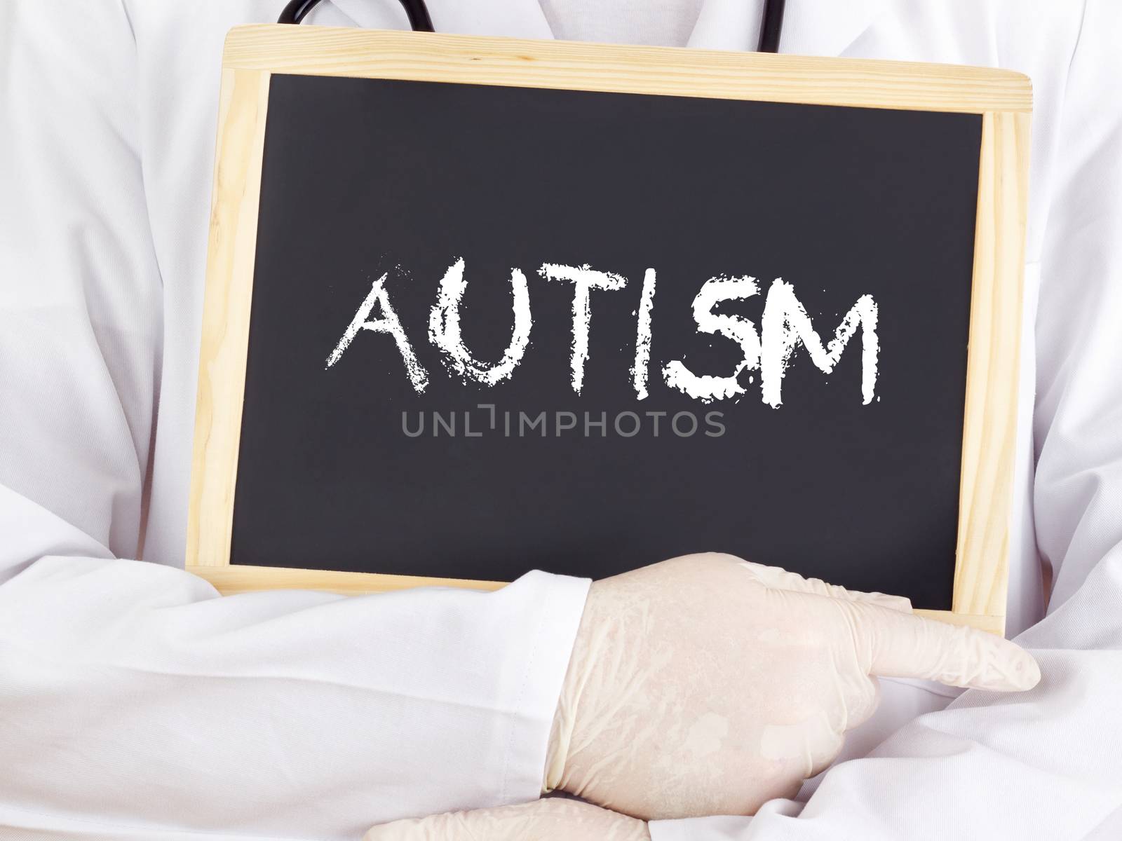 Doctor shows information on blackboard: autism by gwolters