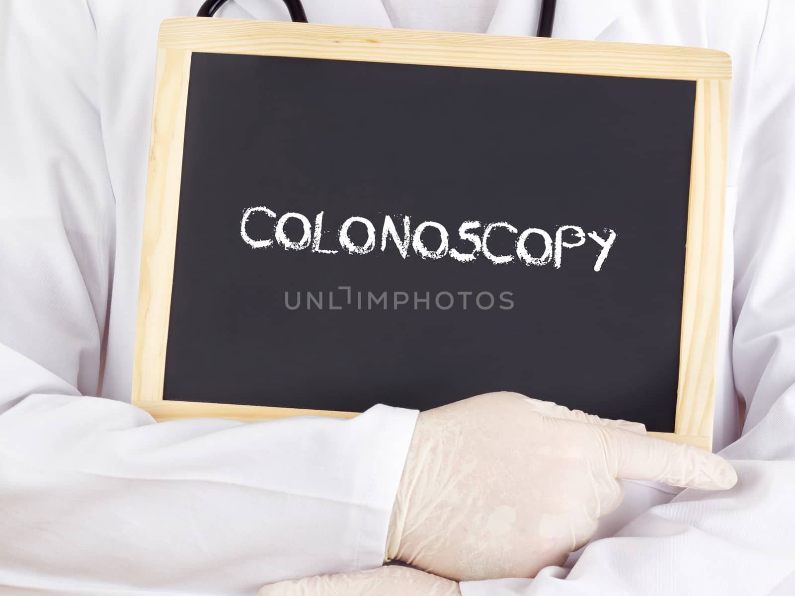 Doctor shows information on blackboard: colonoscopy by gwolters