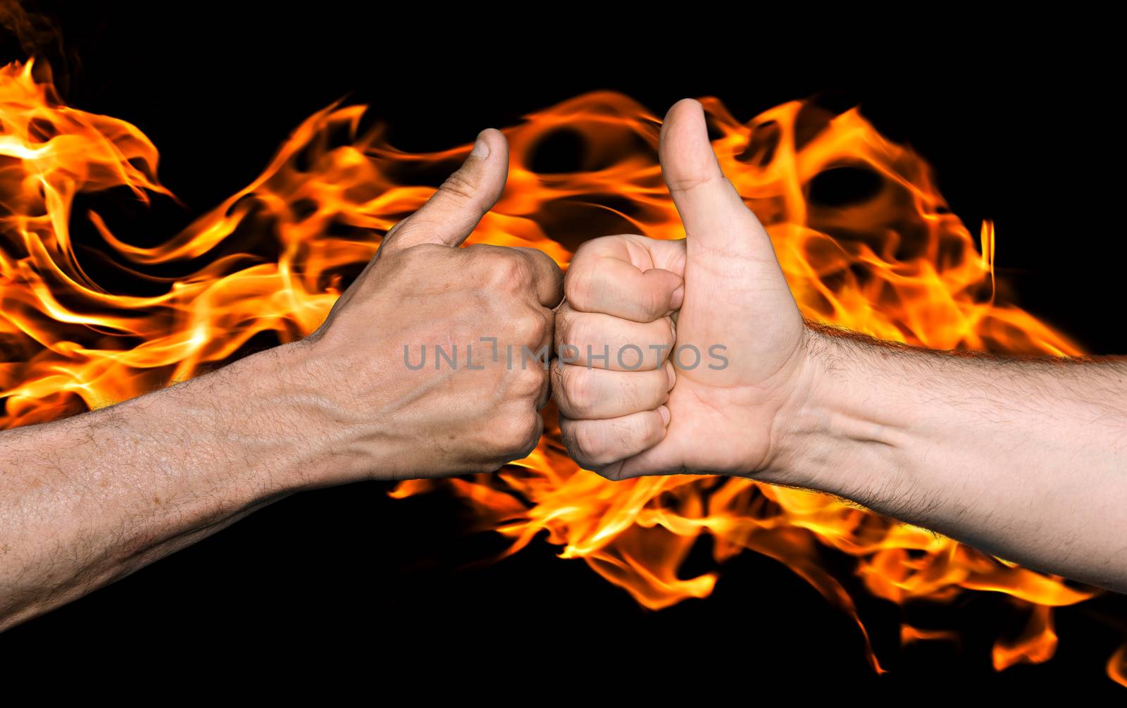 Friendship sealed with fire concept. Two men bumping fists with thumbs up against the fire flames
