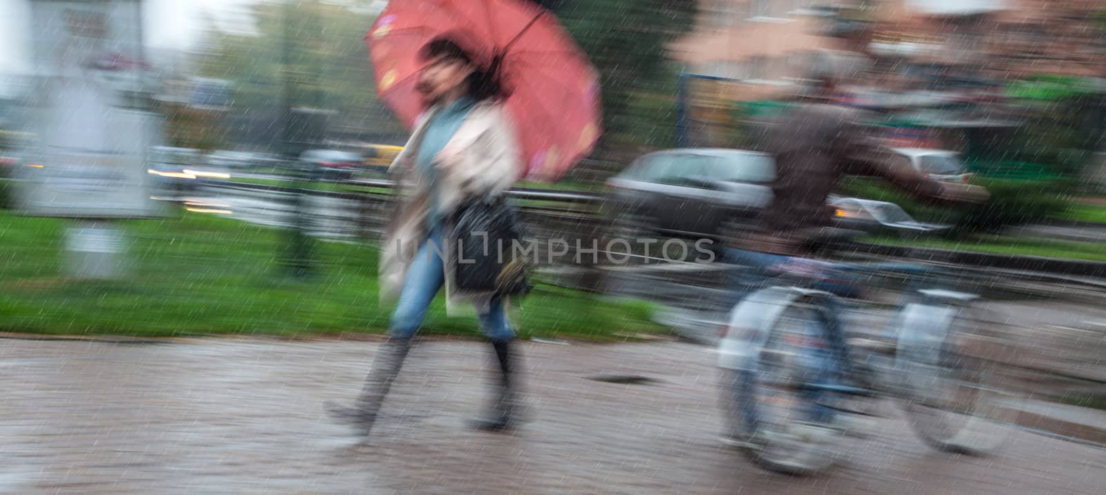 Rainy day in the city  in motion blur. People going about their business