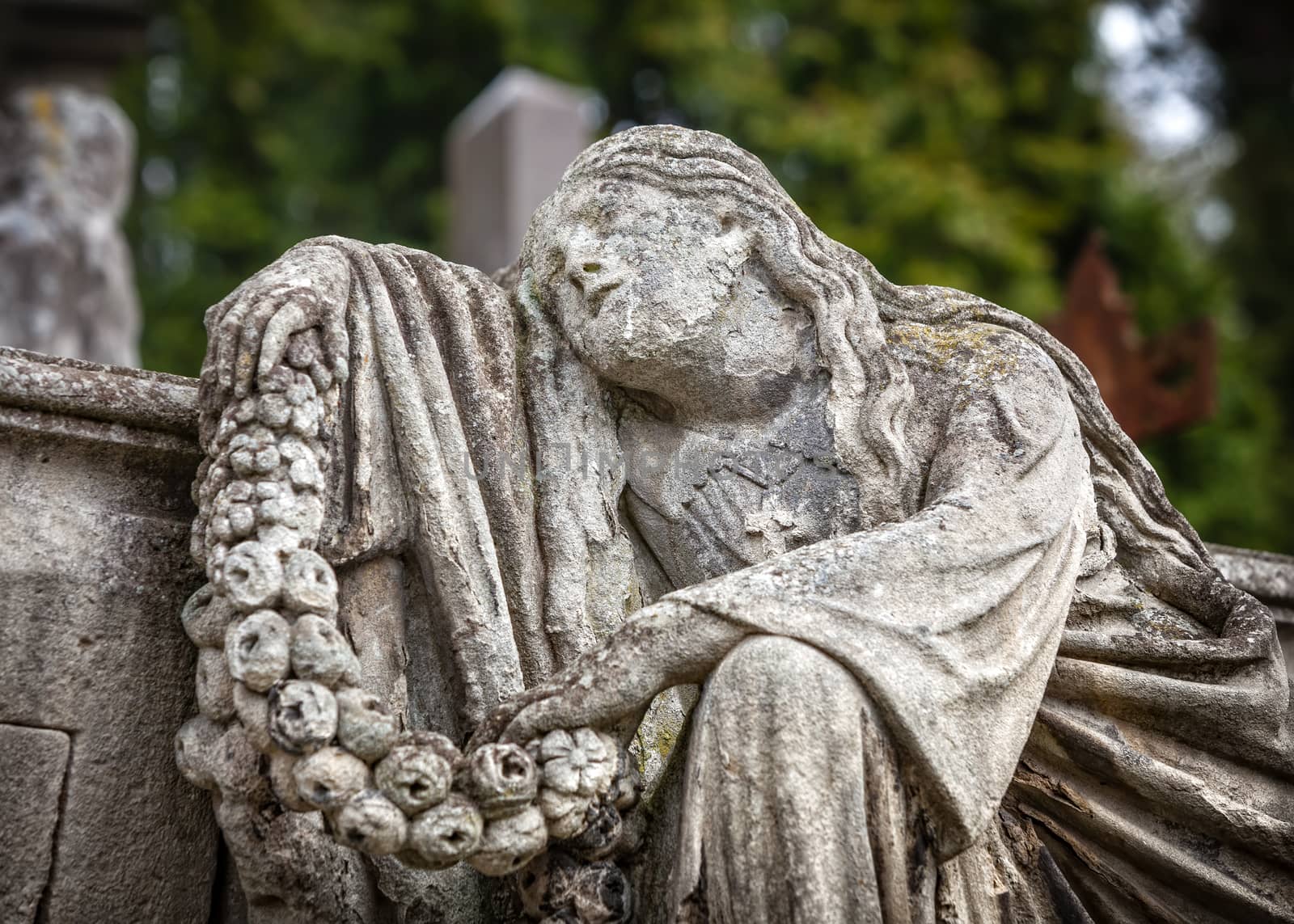 Old statue on grave in the Lychakivskyj cemetery of Lviv, Ukraine.