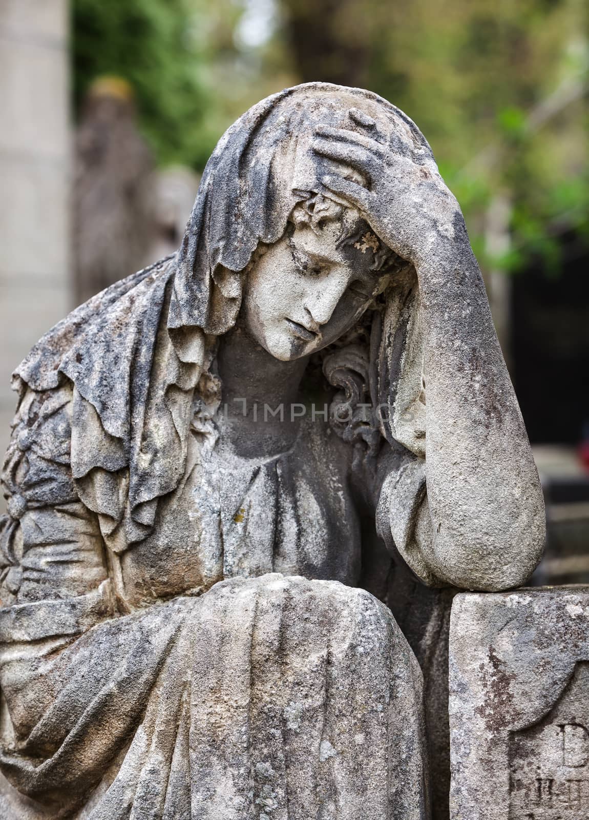 Old statue on grave in the Lychakivskyj cemetery of Lviv, Ukraine.