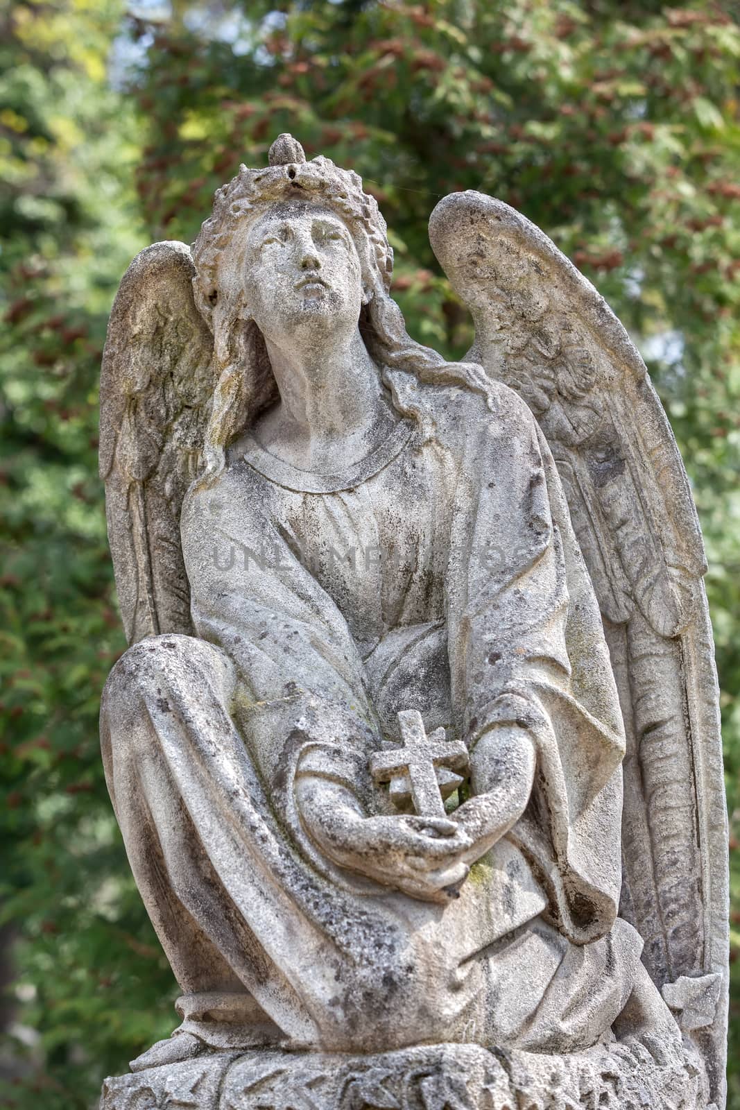 Old statue on grave in the Lychakivskyj cemetery of Lviv, Ukraine.