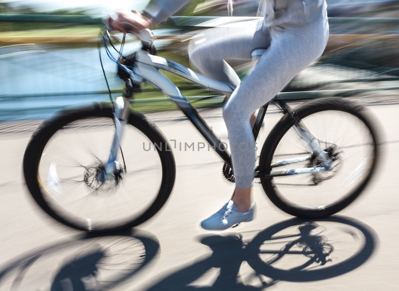 cyclist in traffic on the city roadway. Intentional motion blur