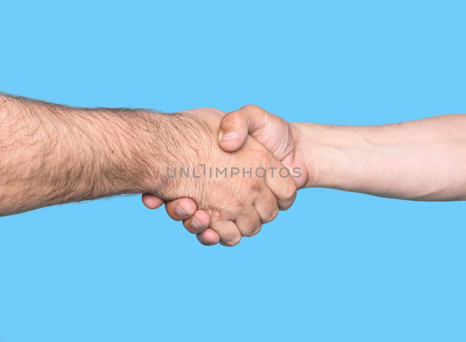 Handshaking. Shaking hands of two male people, isolated on blue