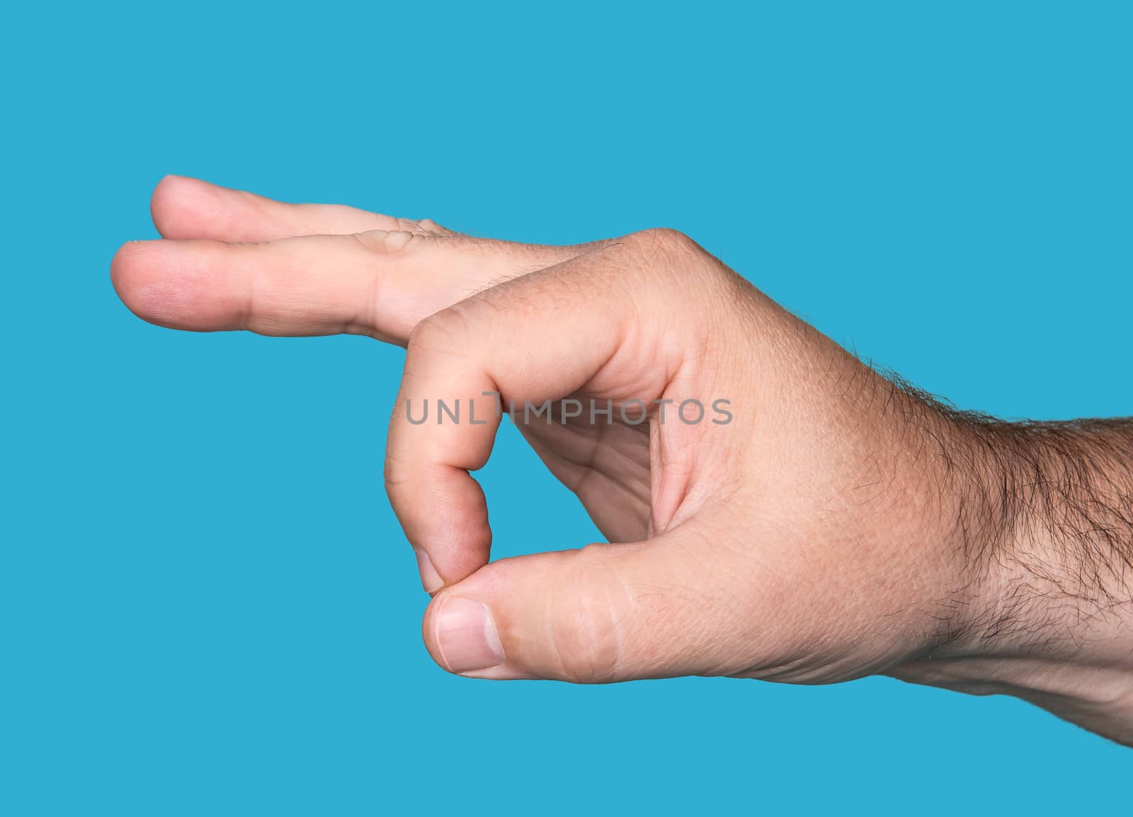 Hand OK sign isolated on blue background