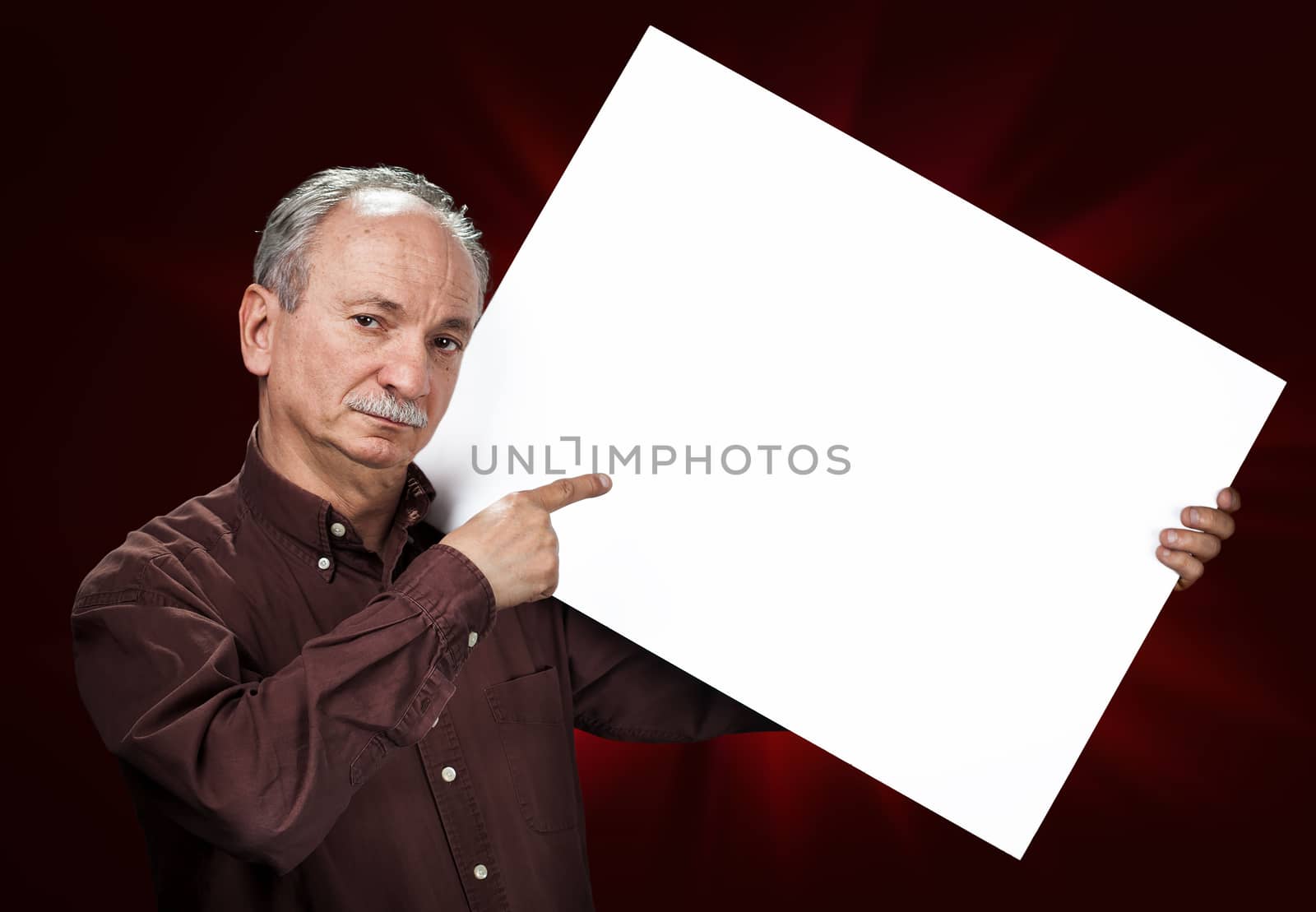 An elderly man holding a blank billboard