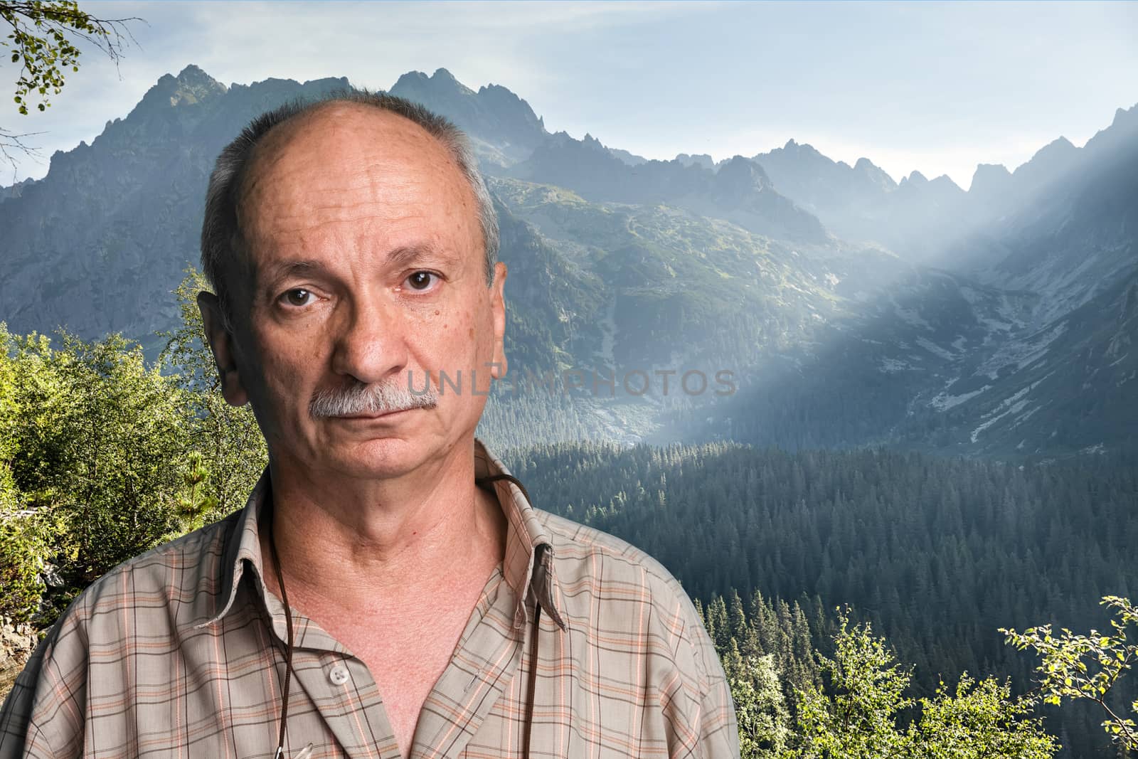 Happy old man in mountains - closeup shot. Shot in High Tatra Mountains. Slovakia. Europe.