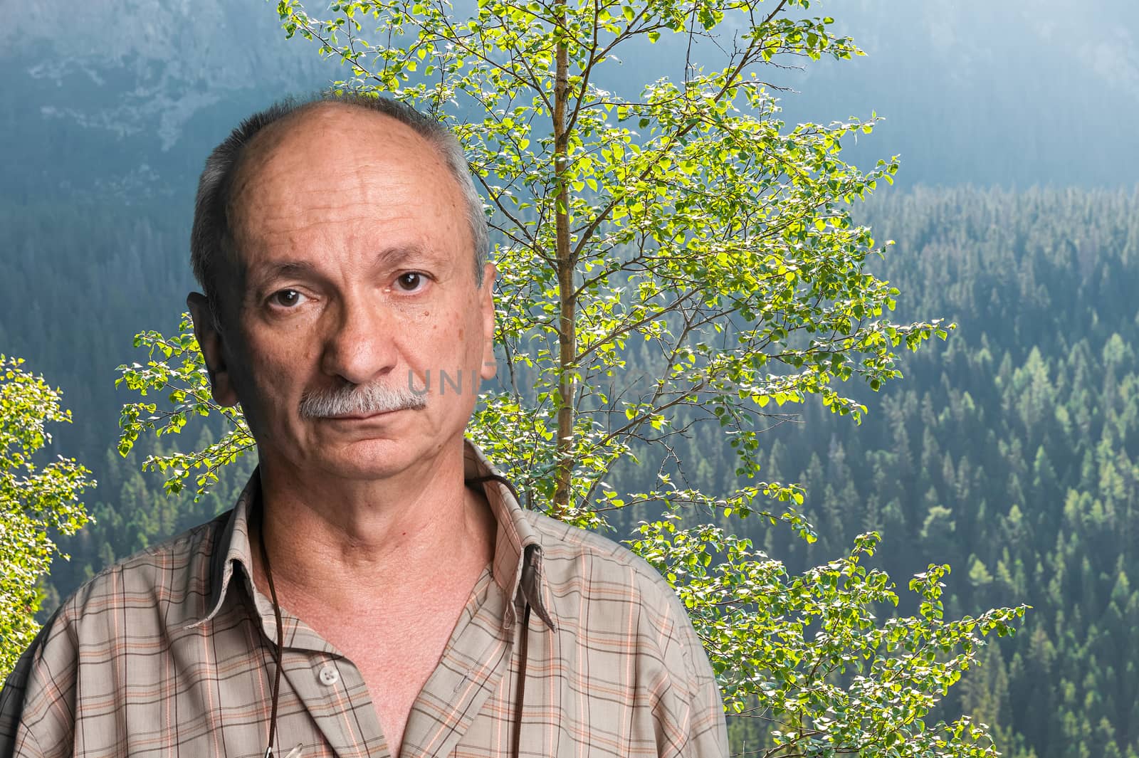 Happy old man in mountains - closeup shot. Shot in High Tatra Mountains. Slovakia. Europe.