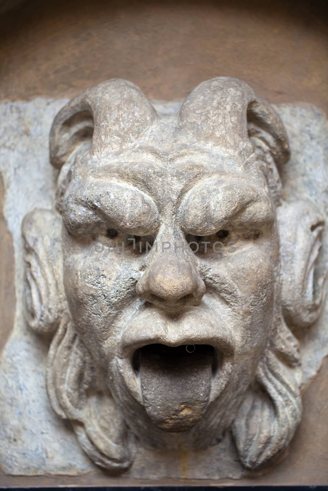 mascaron ornament with sourse of water in collegium maius in cracow