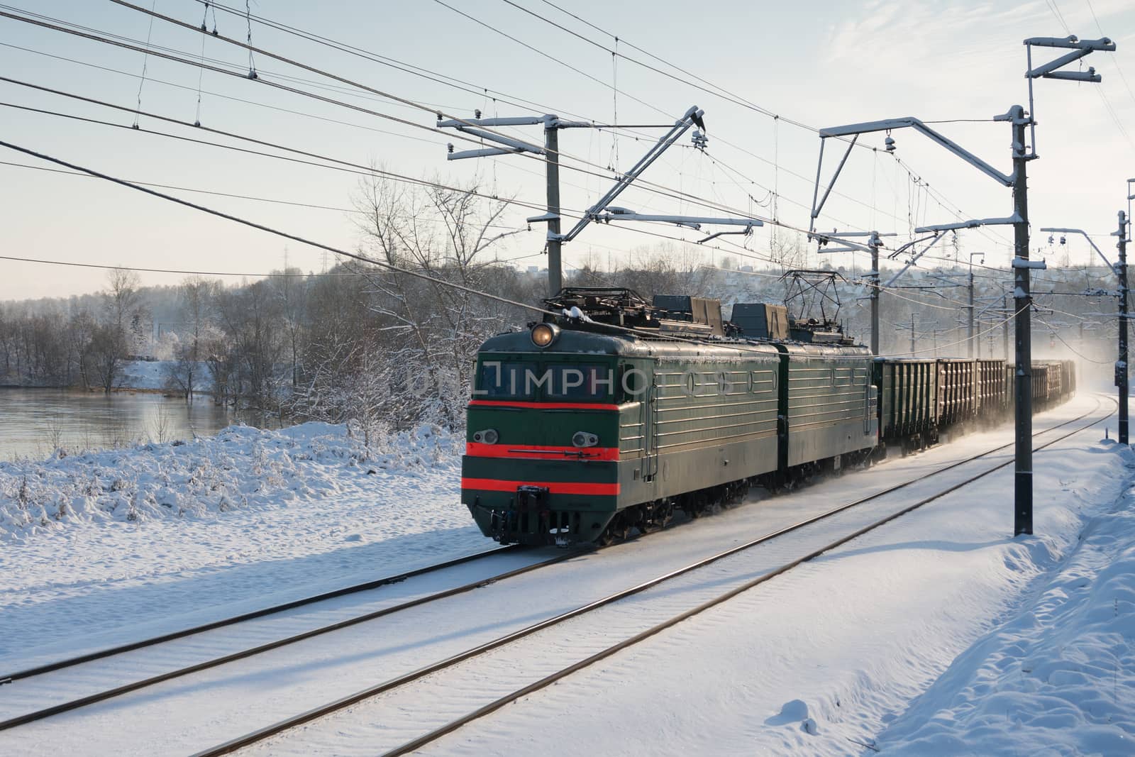 electric locomotive in winter pulls freight train