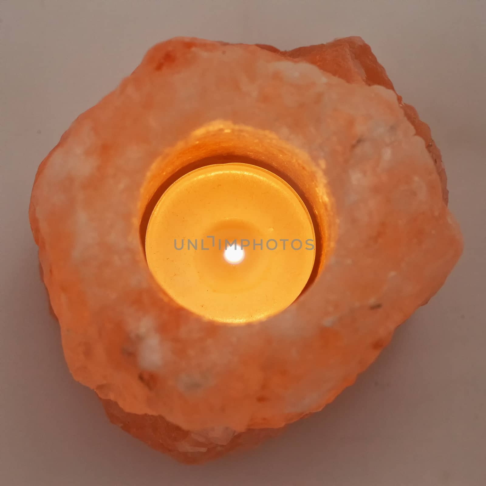 Candle in pink salt stone, square image
