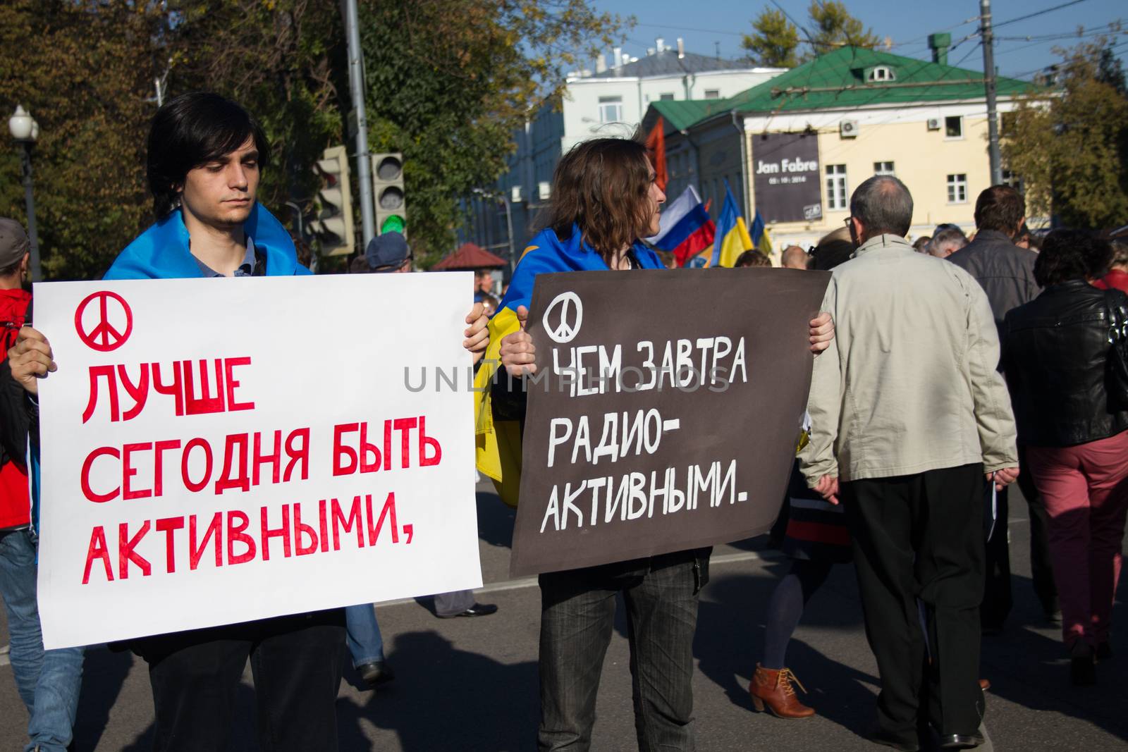 Moscow, Russia - September 21, 2014. Unknown opposition with posters - is better to be active today than tomorrow radioactive Peace March in Moscow against war with Ukraine