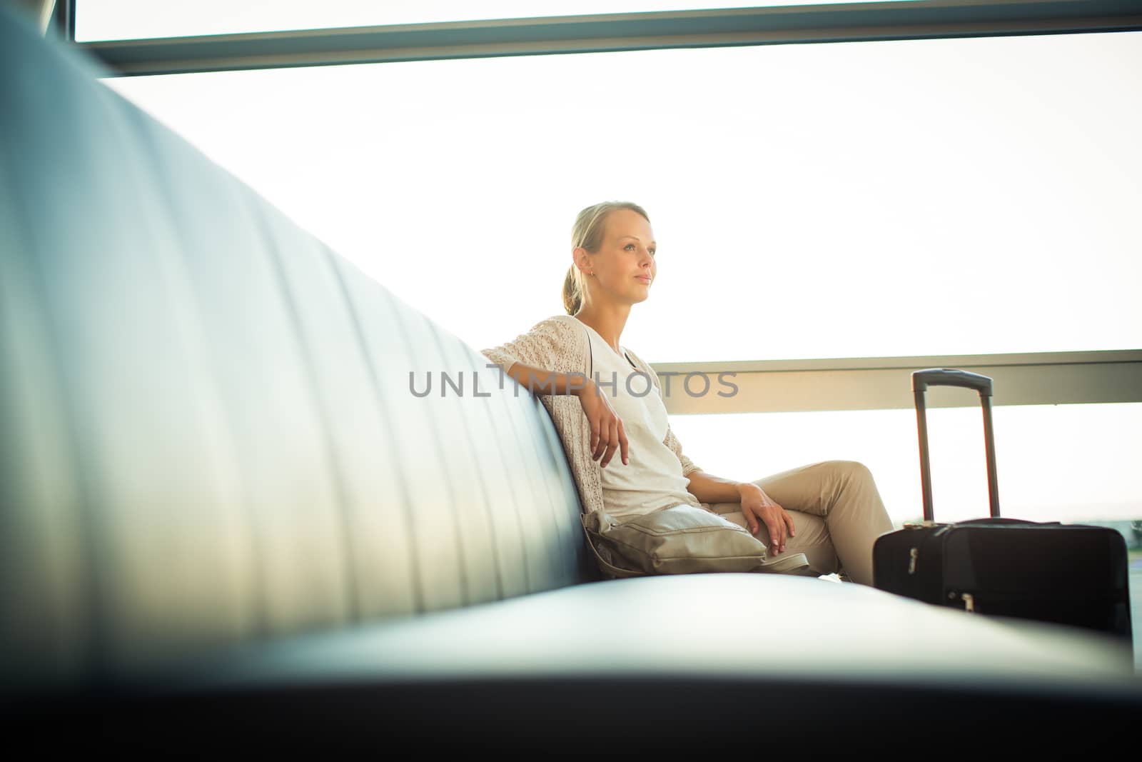 Young female passenger at the airport, using her tablet computer by viktor_cap