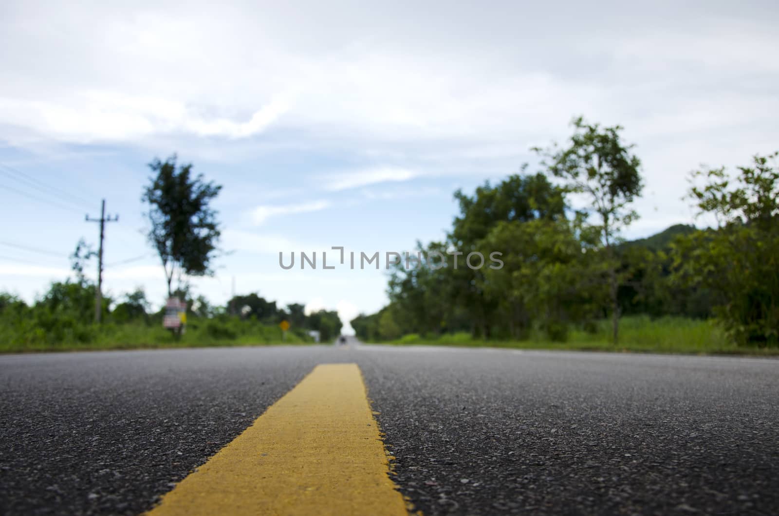 Road in countryside low angle with blurred background by pixbox77