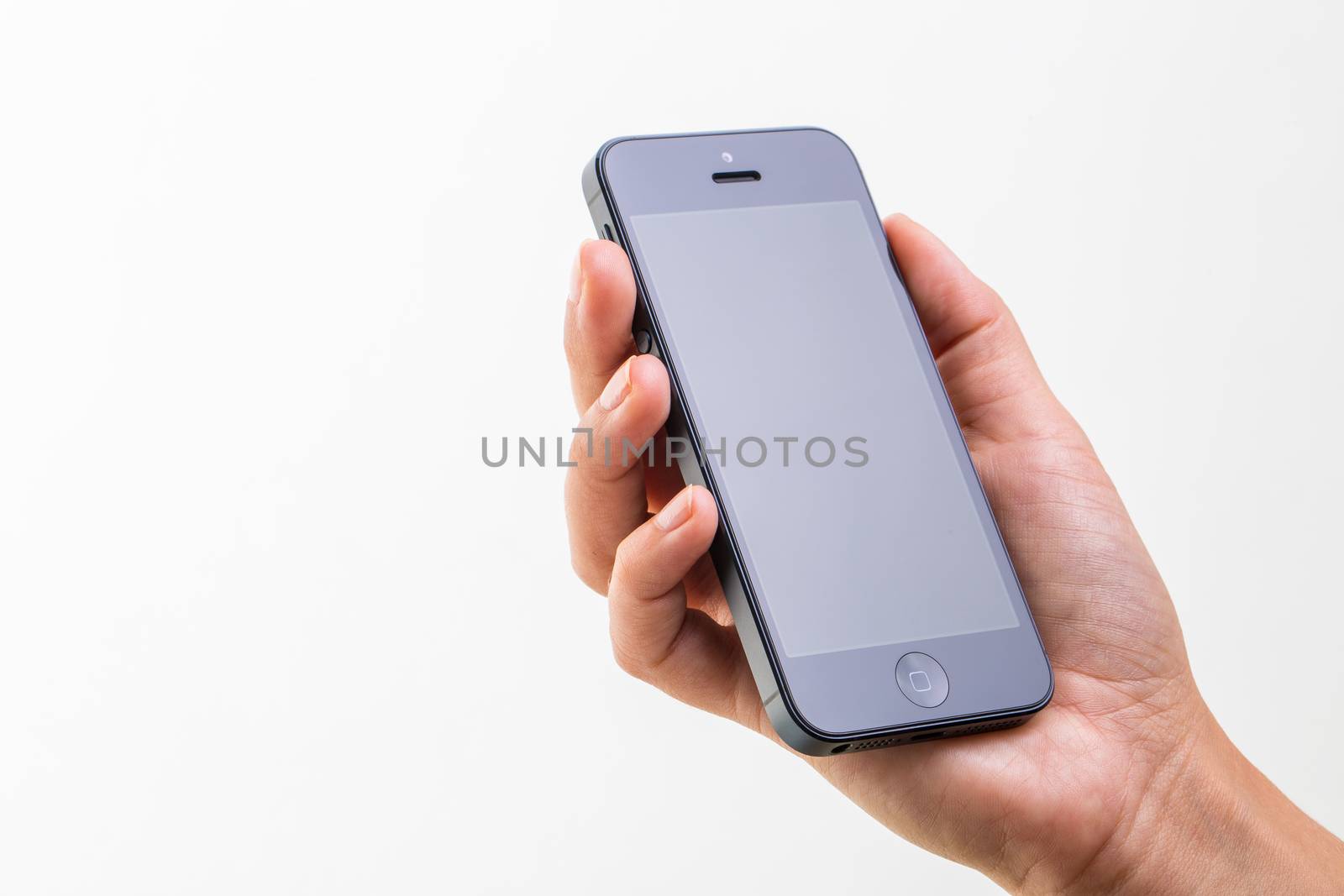 Female hand holding a smart phone, isolated on white