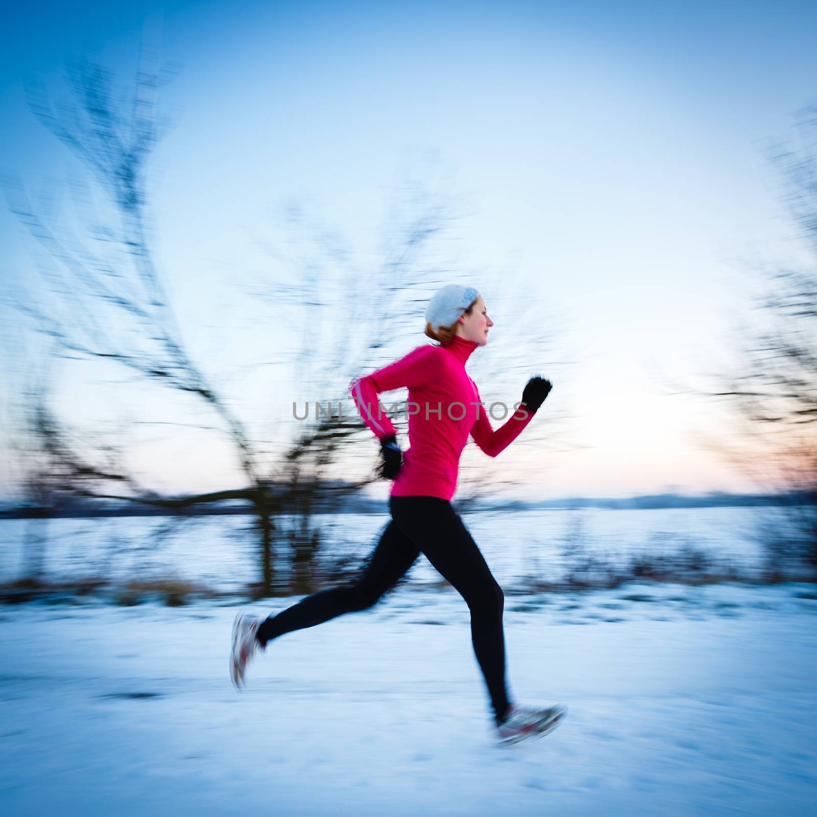 Winter running - Young woman running outdoors by viktor_cap